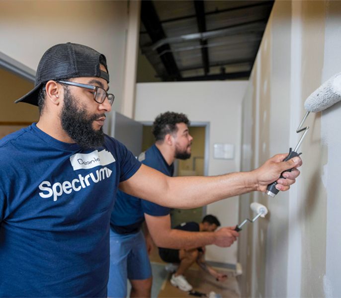 Spectrum Community Center Assist volunteers painting a community center interior